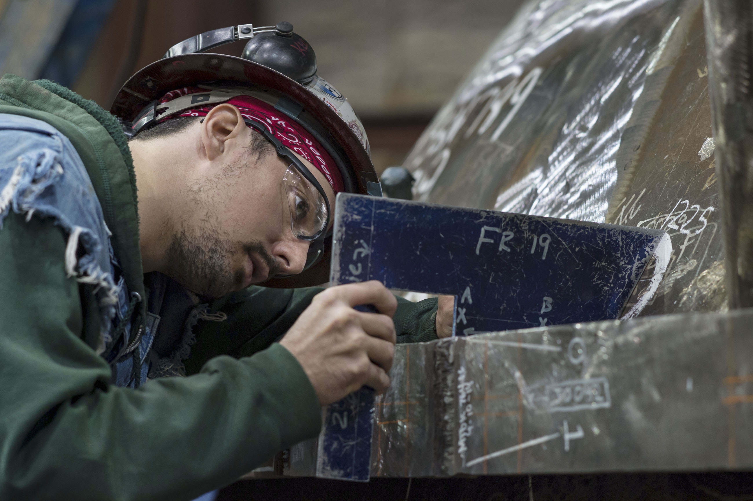 Newport News Shipbuilding inspector Larry Kellum checks dimensions on the submarine Indiana (SSN 789) at Newport News Shipbuilding in 2014.